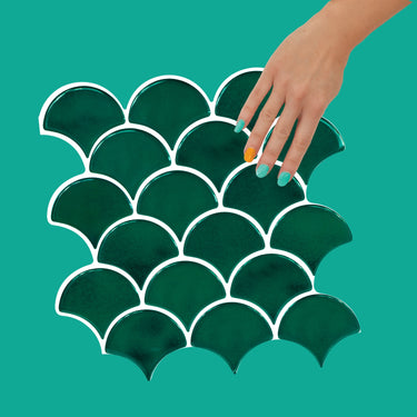 Green oriental fan tile with white grout that is peel and stick